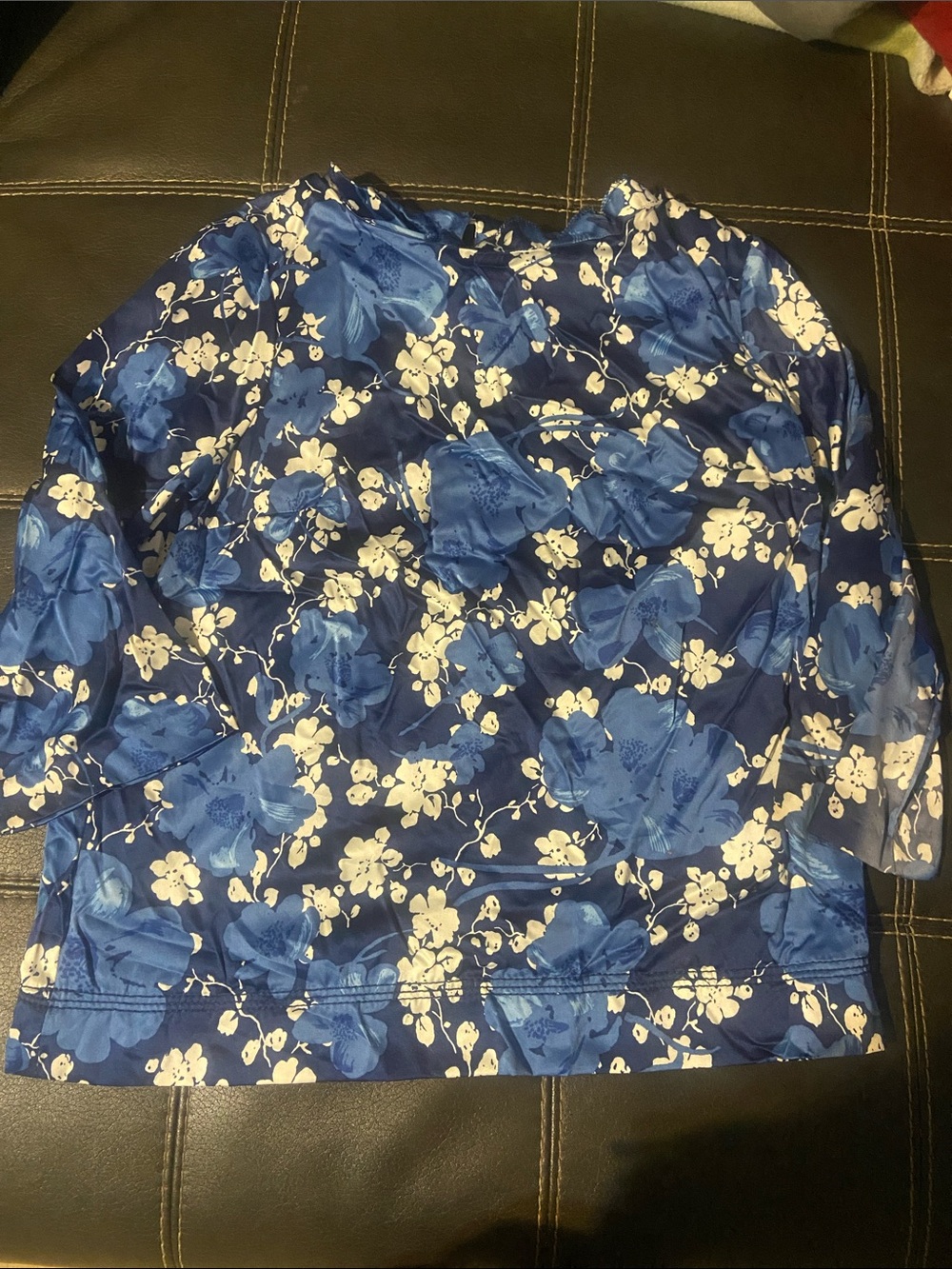 lady’s blue and white floral blouse